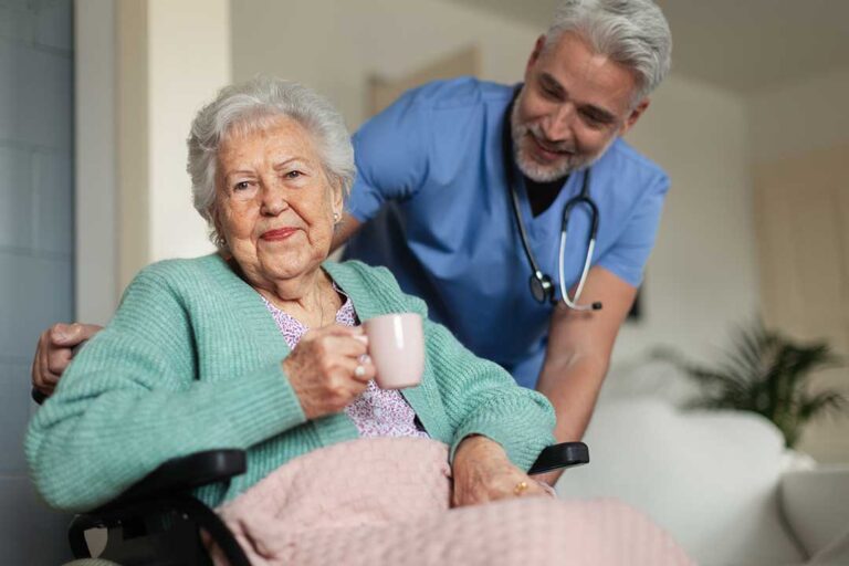 Older adults and children create artwork together around a bright assisted living activity table.